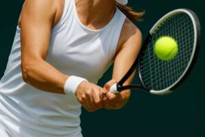 Dynamiczne zbliżenie na tenisistkę uderzającą piłkę podczas meczu – symboliczne ujęcie do artykułu „Gdzie oglądać mecz Świątek – Sorana Cirstea 13.08.2025 – transmisja w Polsce”.